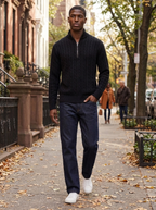 Model wearing a knit quarter-zip stand collar pullover on an autumn city sidewalk
