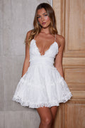 White lace mini dress with plunge neckline and adjustable straps