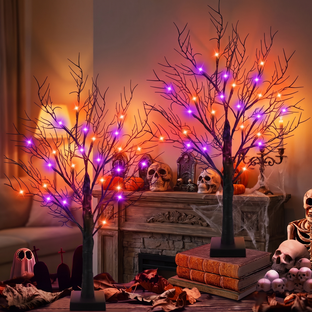 Lit twig trees on a fireplace mantel
