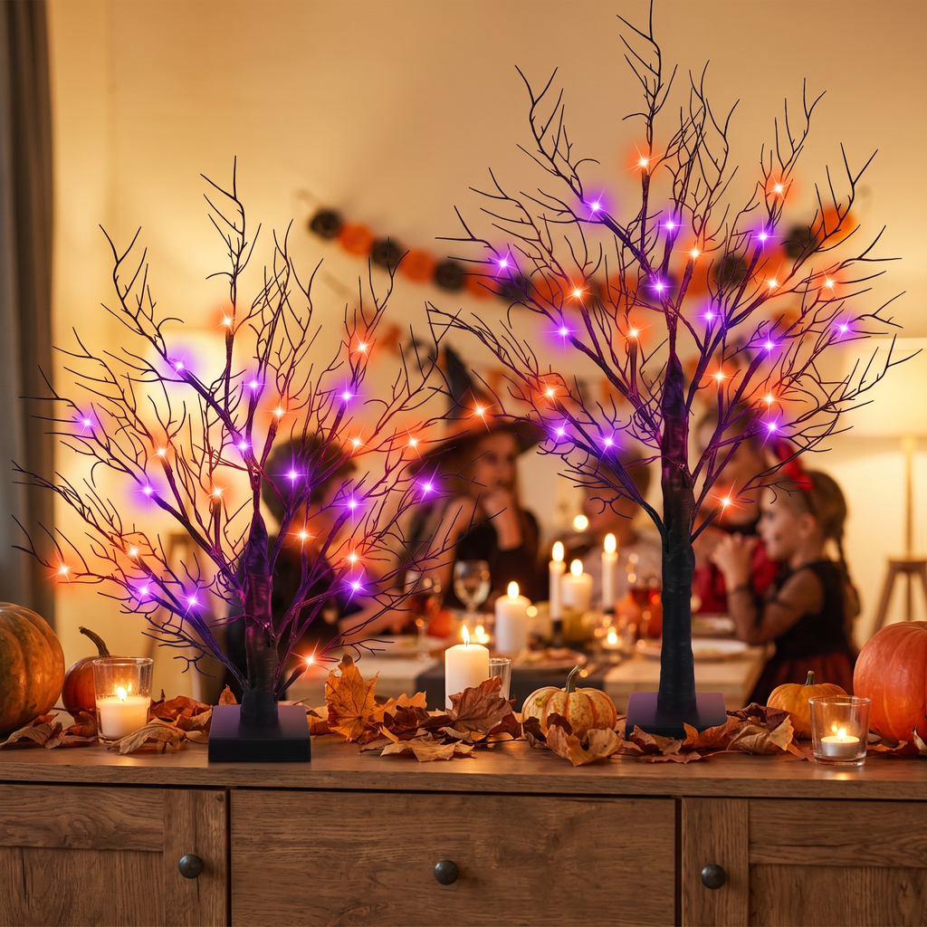 Lit Halloween trees on a sideboard at a gathering
