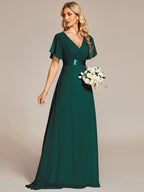 Long chiffon bridesmaid dress with empire waist and flutter sleeves in dark green