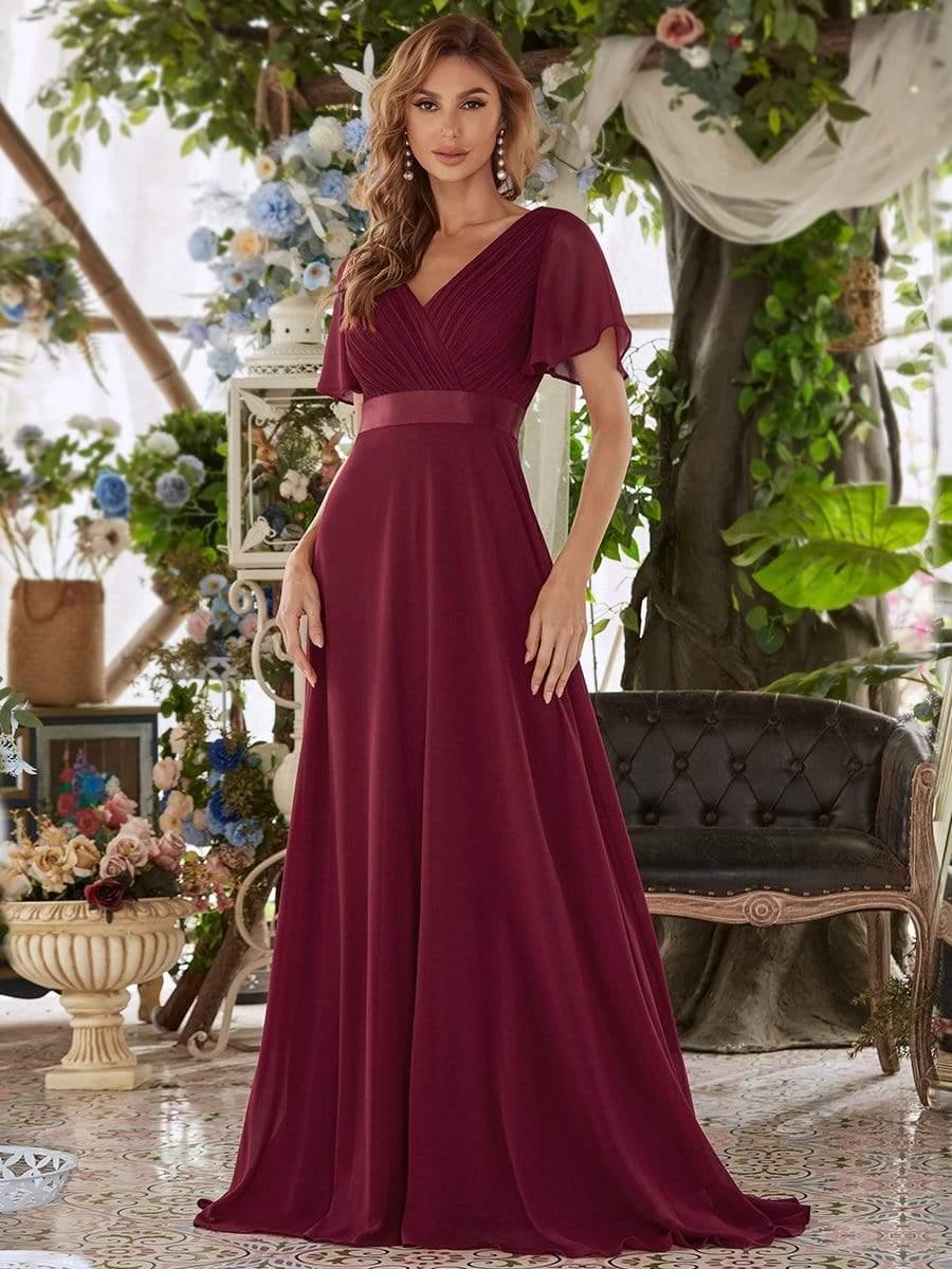 Long chiffon bridesmaid dress with empire waist and flutter sleeves in burgundy