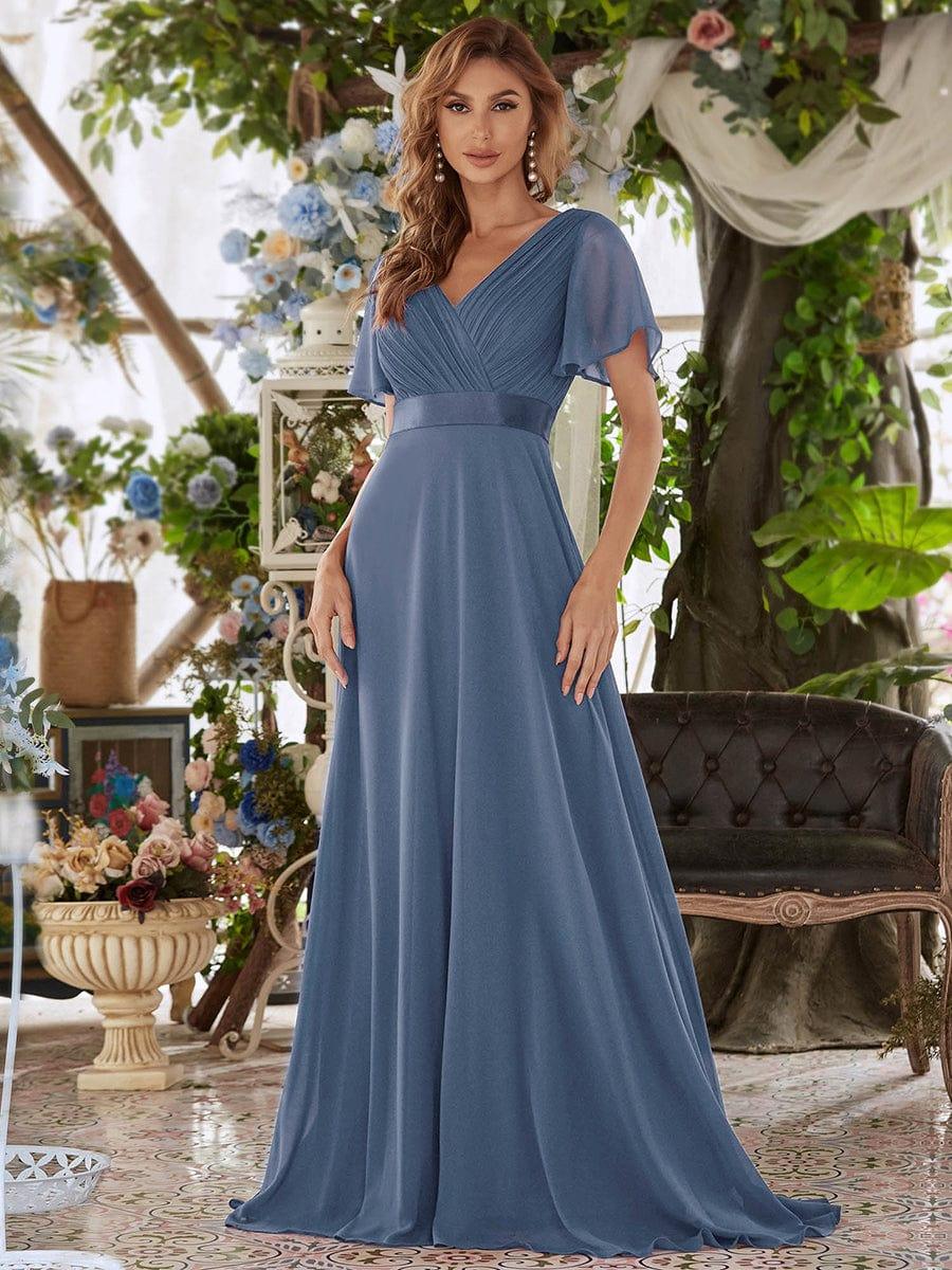 Long chiffon bridesmaid dress with empire waist and flutter sleeves in dusty blue