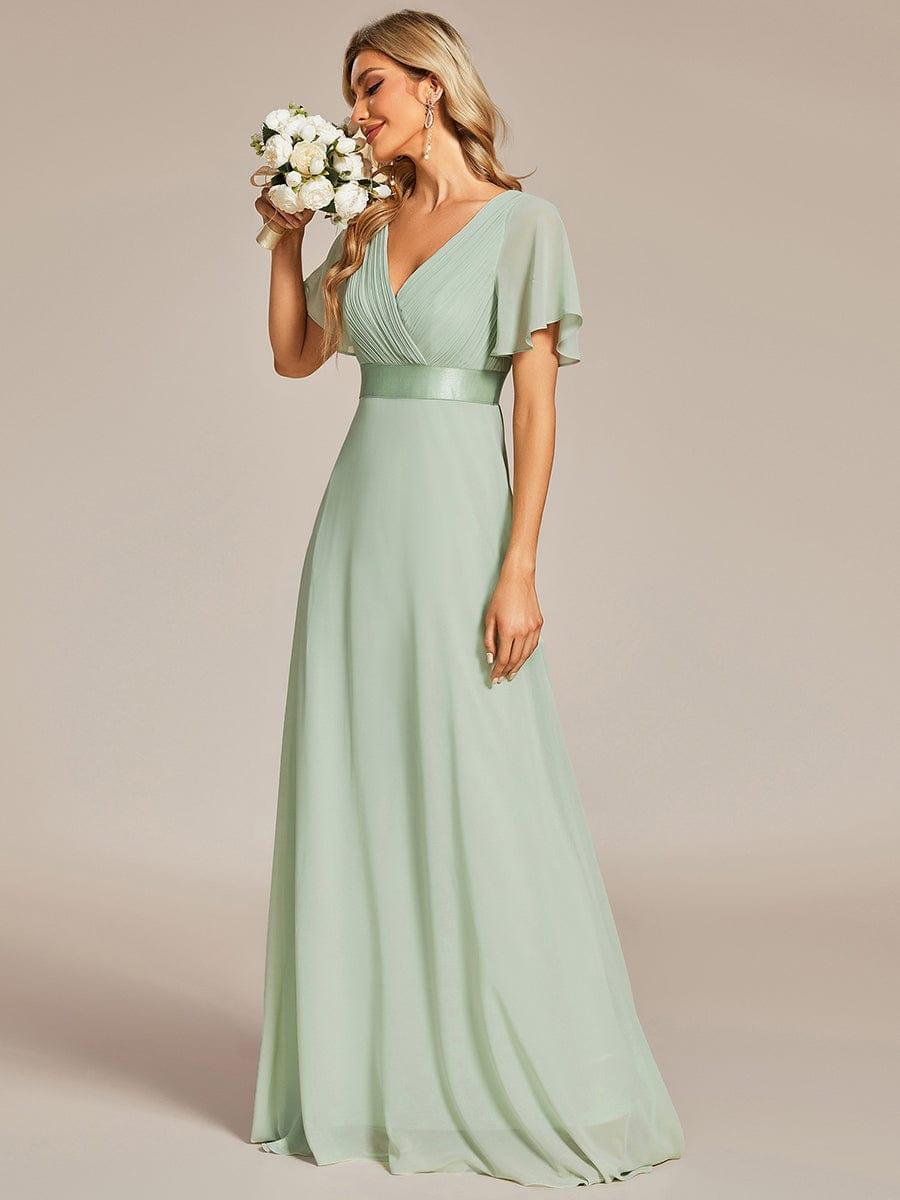 Long chiffon bridesmaid dress with empire waist and flutter sleeves in mint green