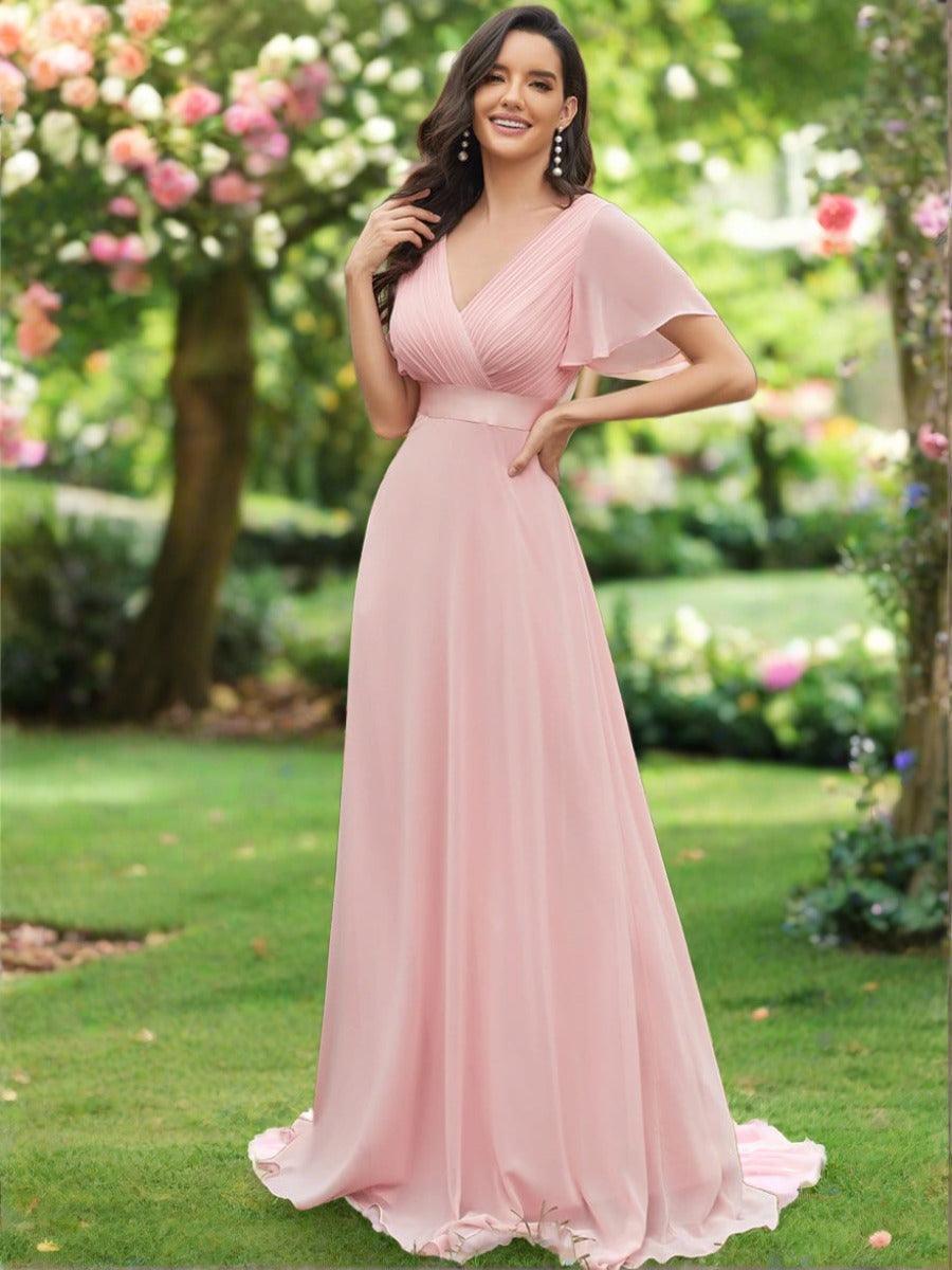 Long chiffon bridesmaid dress with empire waist and flutter sleeves in pink