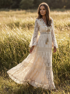 Model wearing a beige flowing long sleeve bohemian maxi dress in a sunlit meadow