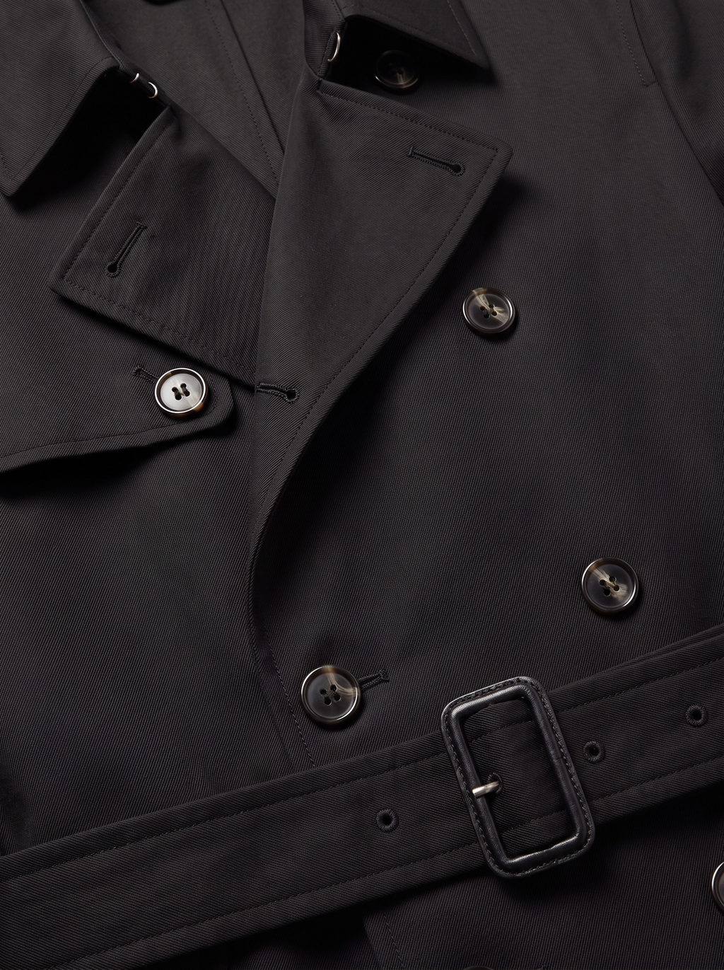 Close up of trench coat lapel, buttons and waist belt