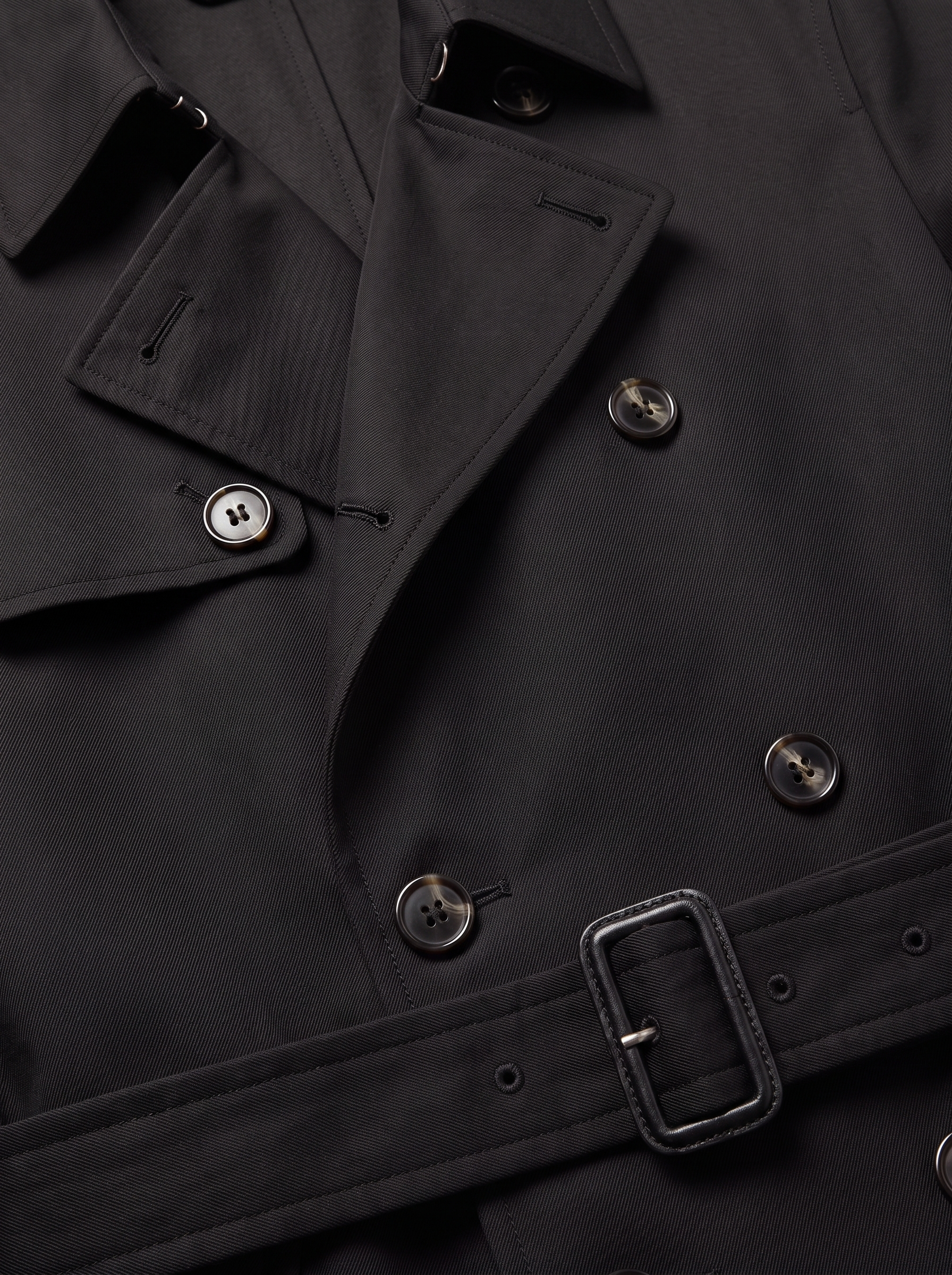 Close up of trench coat lapel, buttons and waist belt