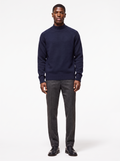 Navy mock neck raglan sweater worn by model, front view