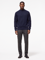 Navy mock neck raglan sweater worn by model, front view