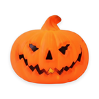 Pumpkin ghost-face LED lamp on a white background