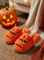 Pumpkin monster slippers beside a carved jack o lantern