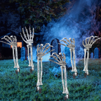 Skeleton hands emerging from a foggy lawn at night