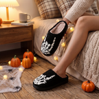 Skull plush slippers styled on a floor with cozy Halloween decor