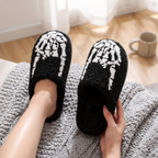 Close up of the skeleton skull plush slipper design