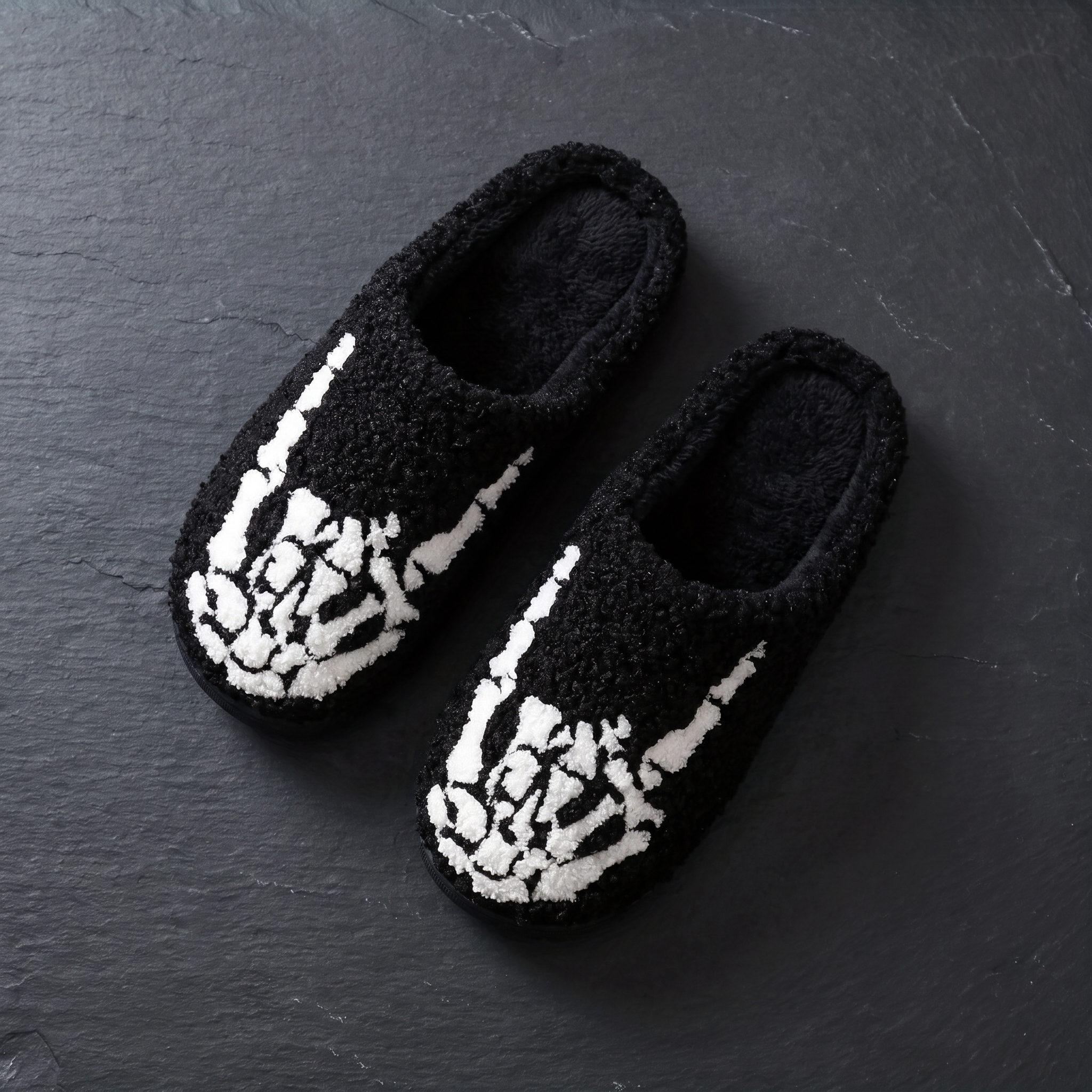 Flat lay of the pair of skull plush slippers