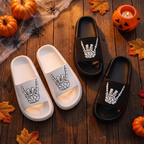 Skull hand slides styled on a floor with Halloween decor