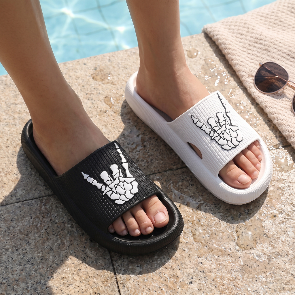 Feet wearing the skull hand slide sandals