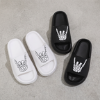 Flat lay of the pair of skull hand slide sandals