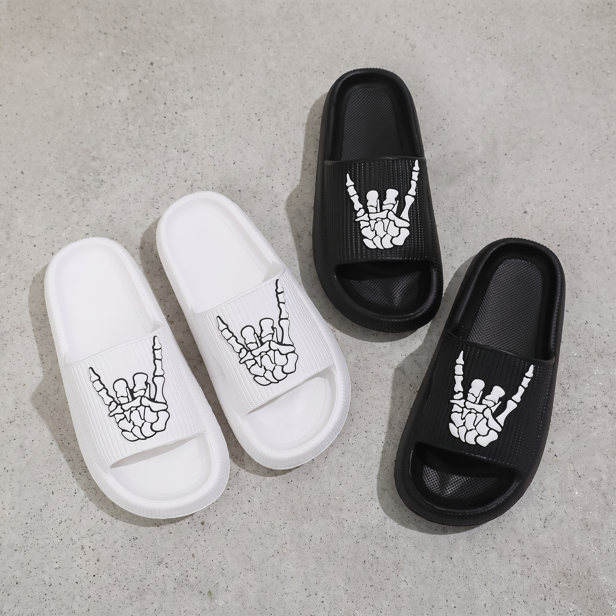 Flat lay of the pair of skull hand slide sandals