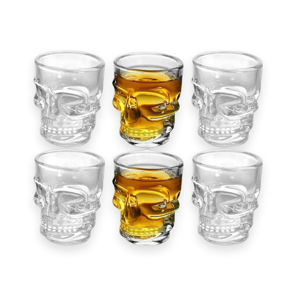 Clear skull-shaped shot glasses on a white background