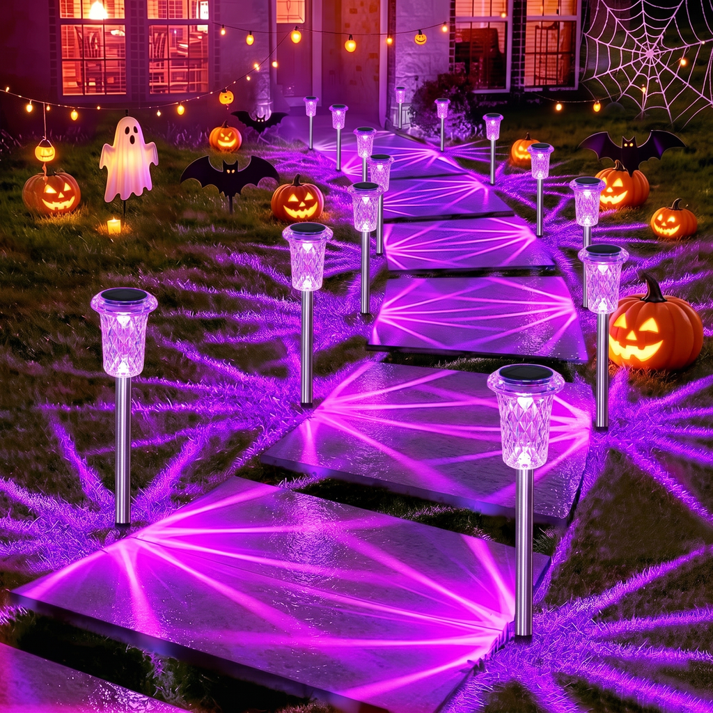 Purple solar pathway lights along a walkway lined with glowing pumpkins