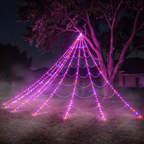 Giant LED spider web spanning a tree and lawn in a foggy front yard