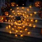 Close-up of the glowing LED web with the furry black spider in the center
