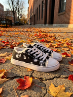 Lace-up sneakers on an autumn sidewalk
