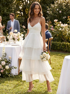 White tiered ruffle midi dress with adjustable straps at a garden celebration
