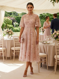 Tulle A-line midi cocktail dress with short sleeves at a garden reception