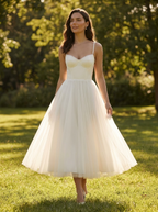 Tulle midi dress with sweetheart neckline and A-line skirt on a park lawn