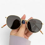 Round lens sunglasses detail view of frame and temple arm