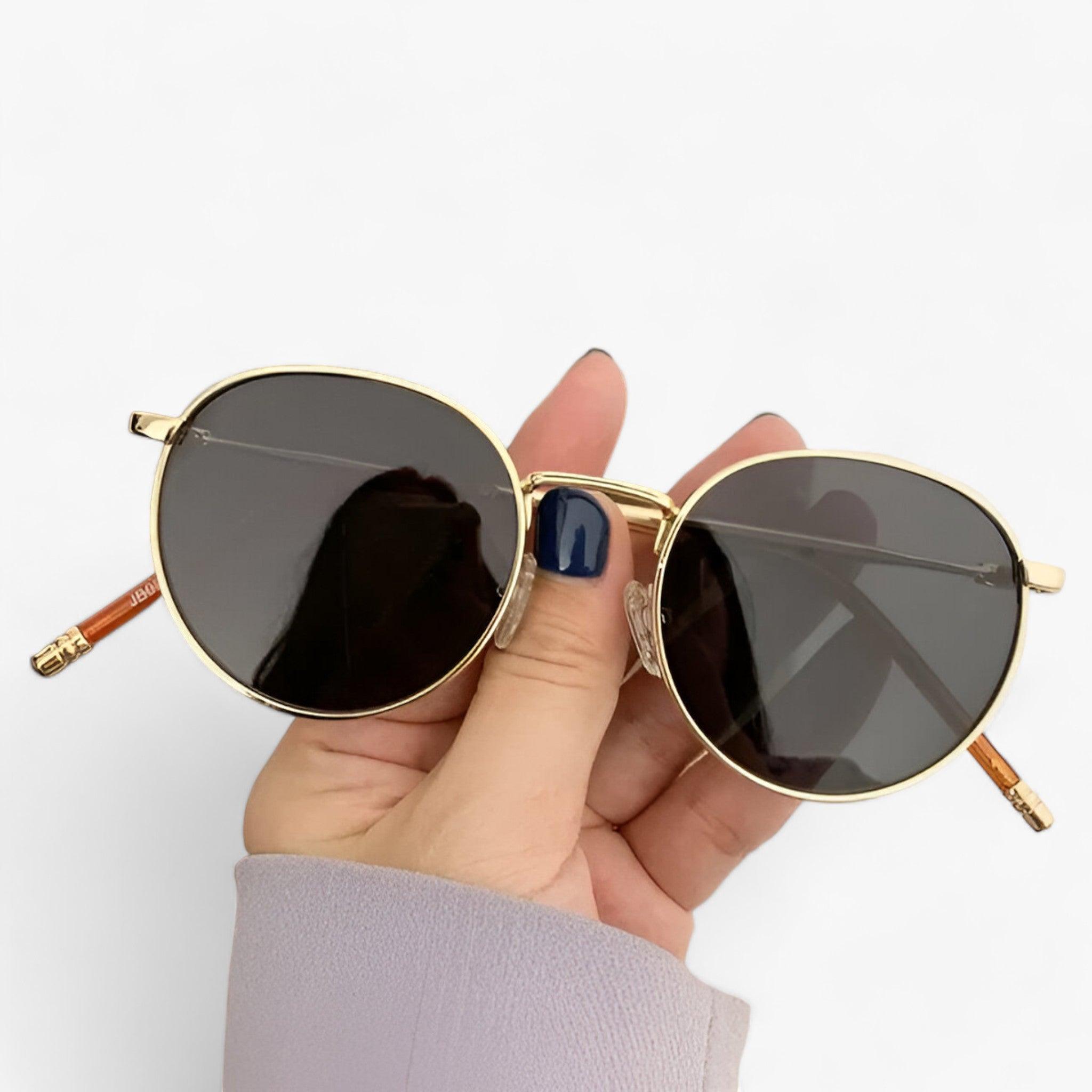 Round lens sunglasses detail view of frame and temple arm