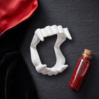Flat lay of vampire fangs with a costume collar and fake blood