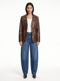 Washed brown faux leather blazer worn by model, front view