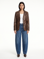 Washed brown faux leather blazer worn by model, front view