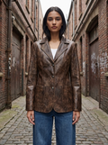 Model wearing a distressed brown washed faux leather blazer