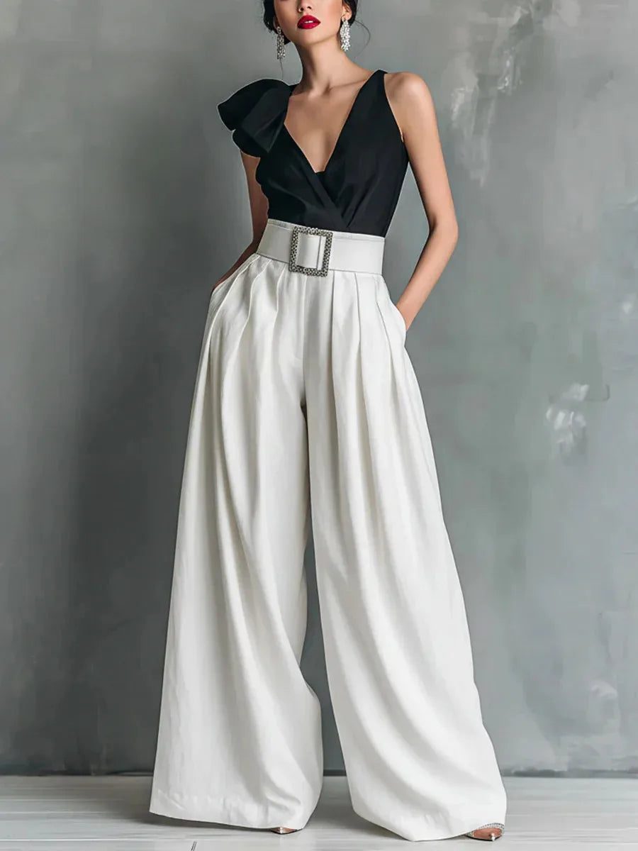 High-waisted wide-leg pants in white, side view showing loose drape