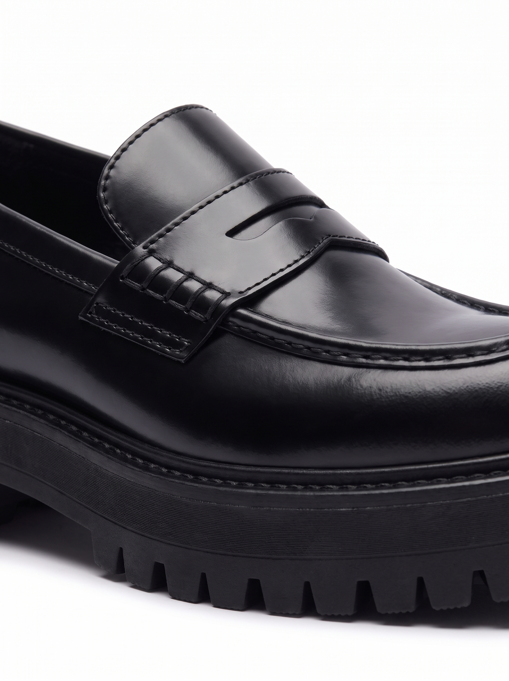 Close up of penny strap and chunky lug sole