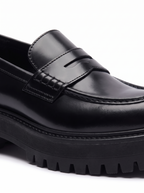 Close up of penny strap and chunky lug sole