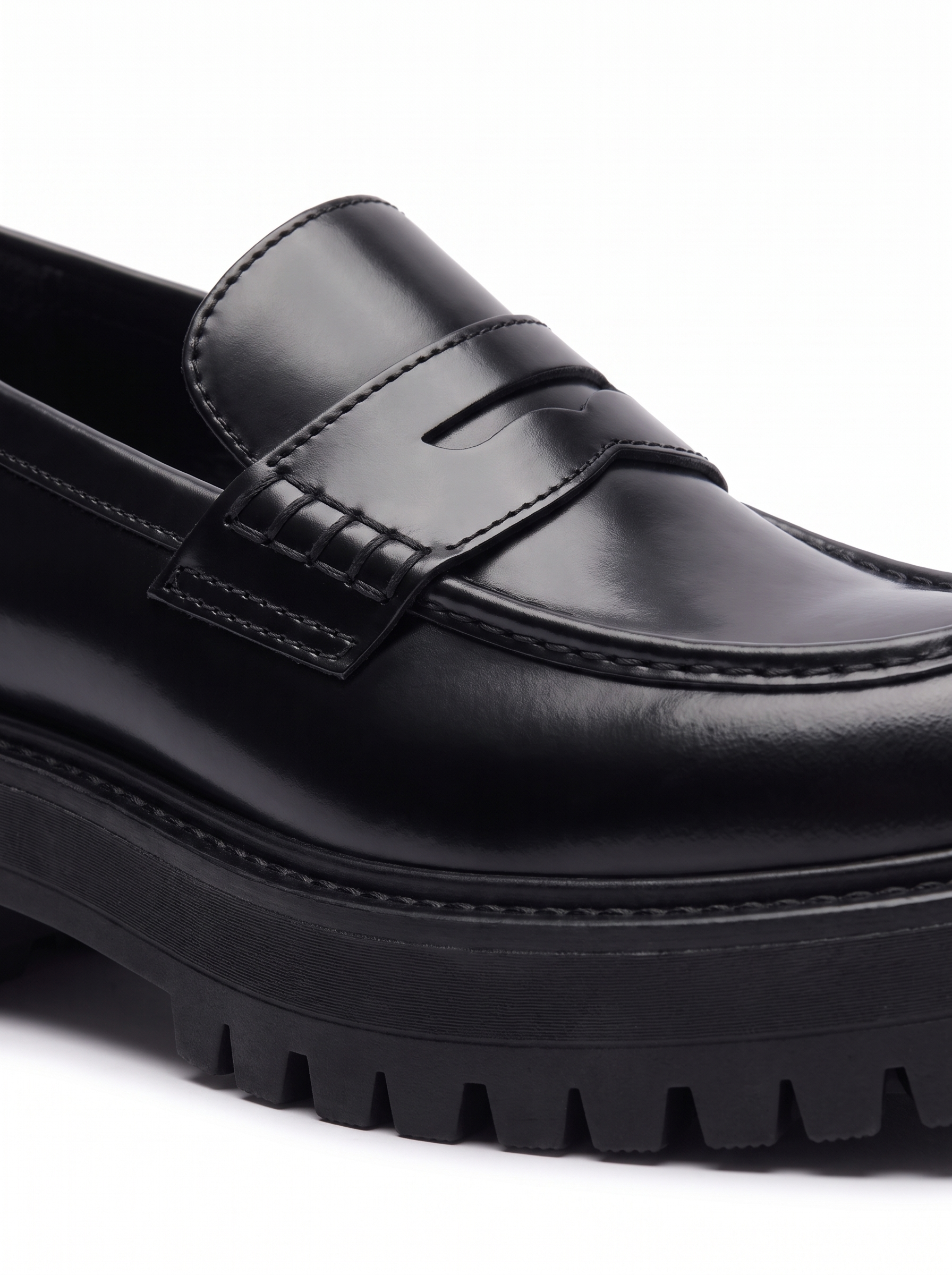 Close up of penny strap and chunky lug sole